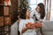 Daughter giving surprise gift to mother during christmas day