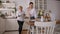 A daughter helps her old mother in the kitchen, they serve the table together.