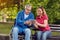 Daughter with her disabled father in wheelchair using tablet