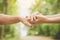 Daughter holding her mother`s hand outdoors over nature background