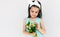 Daughter holds the bouquet of white flowers for her mother. Cute kid holds a bouquet and looking to flowers posing on white