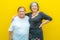 Daughter hugging her mother on a plane yellow background