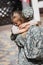 Daughter hugging mother in military uniform