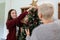 Daughter and mother caucasian decorate Christmas tree to prepare for family& x27;s Christmas Day