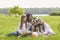 Daughter mother and husky dog in close-up sitting on grass smiling happy at the weekend in summer park.