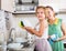 Daughter with mother washing dishes