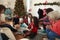 Daughter Opening Gift As Multi Generation Family Celebrate Christmas At Home Together