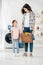 daughter in pink t-shirt standing near mother in grey shirt with basket and