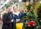 Daughter points her hand to mom as they walk through street Christmas market