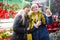 Daughter points her hand to mom as they walk through street Christmas market