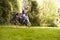 Daughter Pushing Father And Son On Tire Swing In Garden