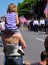 Daughter Riding Mom`s Shoulders at a Memorial Day Parade