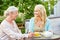 Daughter with senior mother drinking tea at cafe