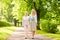 Daughter with senior mother walking at summer park