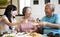 Daughter and senior parent enjoy dinner