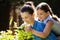 Daughter smelling rose with mother while enjoying piggyback