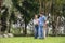 Daughter takes care of father and helps Support, Encourage him during his illness at hospital garden. The happiness of old adult