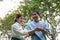 Daughter takes care of father and helps Support, Encourage him during his illness at hospital garden. The happiness of old adult