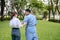 Daughter takes care of father and helps Support, Encourage him during his illness at hospital garden. The happiness of old adult