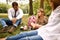 Daughter with their parent sitting and resting at park