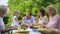 Daughter treating father with watermelon, family having fun while eating dinner