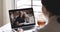 Daughter video calling old parents in webcam chat on laptop