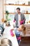 Daughter wearing gloves helping daddy to clean kitchen