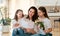 Daughters giving mother bouquet of flowers