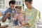 Daughters helping parents with baking