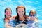 Daughters and mother family swimming in pool
