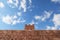 a daunting high brick wall under a clear sky