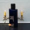 Davidoff Cool Water, Eau de Toilette, large perfume bottle in front of a andelabra with shining candles decorated with a rose