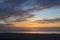 Dawn beauty, picturesque tropical orange coloured stratocumulus cloud coastal sunrise seascape in a blue sky
