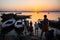 Dawn on Ganges river, with silhouettes of boats with pilgrims.