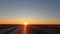 Dawn in the Kazakh steppe. Traveling by car along the highway in Kazakhstan. Morning bright warm sun.