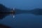 Dawn on the lake in the fog. Lantern on the dock