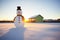 dawn light casting shadow behind snowman