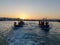 Dawn at sea with fishermen in their boats