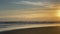 Dawn at sea, morning on the beach, orange dawn. Waves on a sandy tropical beach