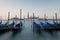 Dawn in Venice with gondolas and mooring posts