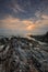 Dawn view of sand beach with rocks