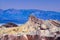 Dawn at Zabriskie Point, Death Valley National Park, California. The colourful formations of Manly Beacon with the Badlands and