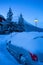 Dawning in the Alps. Car parking in a mountain village in the early morning after a snowfall