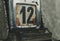 Day 12 number on metal rusty vintage calendar.