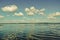 Day beautiful white clouds over the lake reflected clouds waves