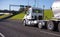 Day cab big rig semi truck with tank semi trailer running on int