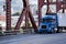Day cab blue big rig semi truck transporting commercial cargo in