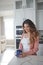 The day doesnt feel right without a cuppa first. a beautiful young woman having coffee in the kitchen at home.