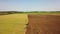 Day time. Tractor working in the field plowing soil.