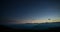 Day to night time lapse from high up on the Alps. Colorful sunset over mountain peaks and fog in the valleys below, moving clouds,
